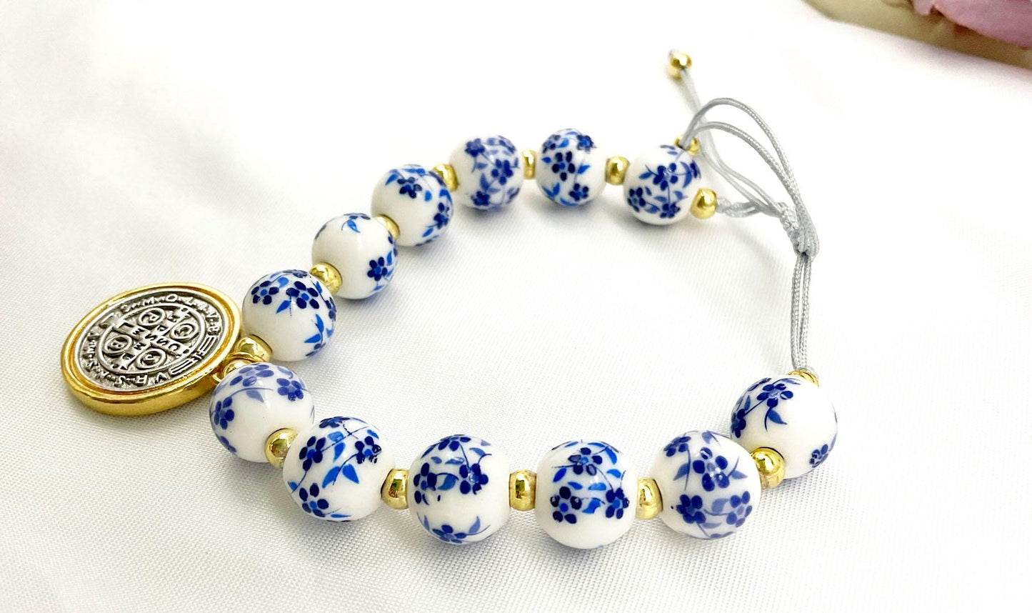 Saint Benedict Pendant Charm Bracelet - Porcelain Beaded Catholic Bracelet, Blue and White Floral Design, Adjustable Cord 18K Gold Plated
